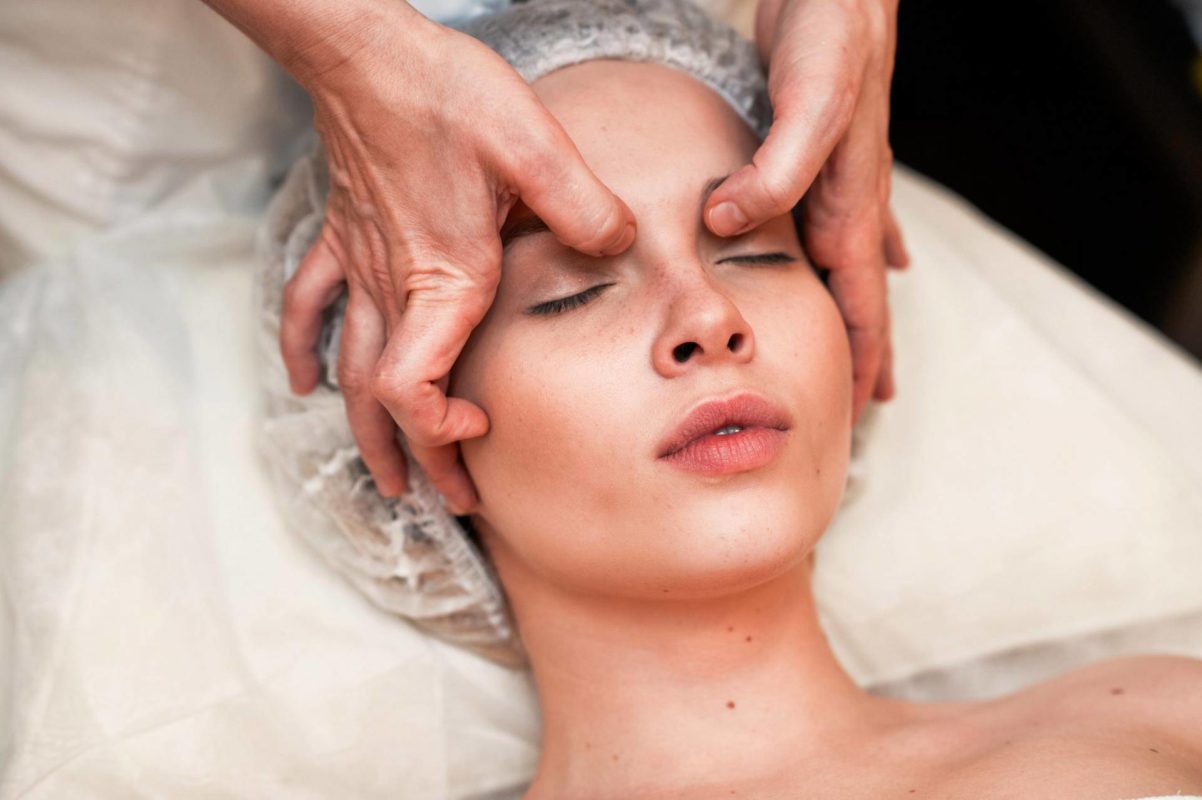 Therapist applying myofascial massage techniques to the facial bones, focusing on releasing tension and improving tissue health